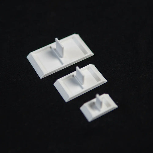 Three empty ant feeding dishes in different sizes