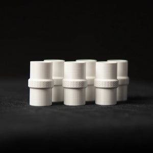 White connector joining two ant test tubes