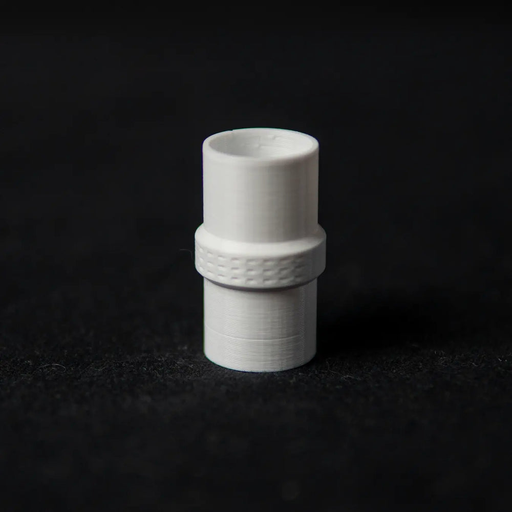 White connector joining two ant test tubes