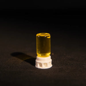 Ant nectar dispenser in a clear tube with white base